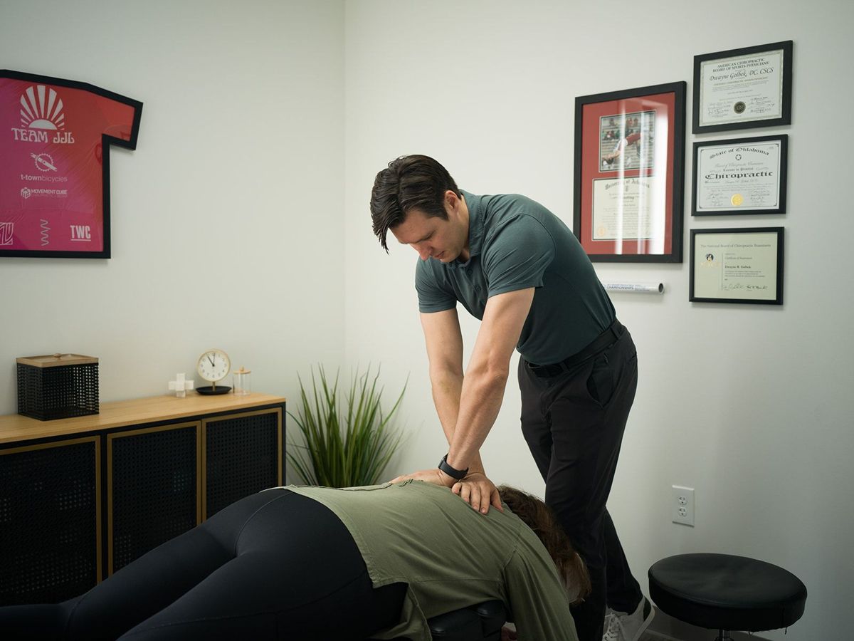 Dr. Dwayne Golbek treating a patient at Movement Cube Chiropractic + Rehab, next door to the gym